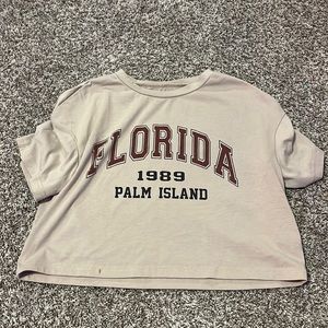 tan shirt with florida written on